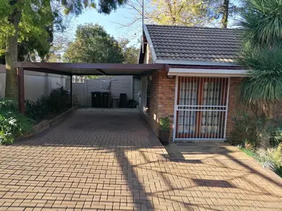 a brick house with a garage and a driveway at Inviting 3-Bed House in Kempton Park in Kempton Park