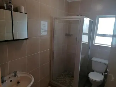 a bathroom with a shower and a toilet and a sink at Inviting 3-Bed House in Kempton Park in Kempton Park