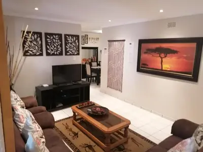 a living room with a couch and a coffee table at Inviting 3-Bed House in Kempton Park in Kempton Park