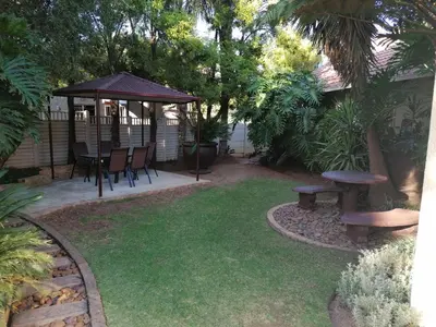 a backyard with a picnic table and a gazebo at Inviting 3-Bed House in Kempton Park in Kempton Park