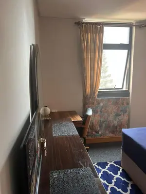a small room with a table and a window at Just a Room in Pretoria