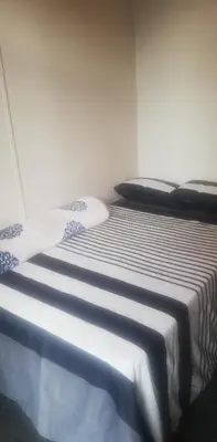 two beds sitting next to each other in a room at Just a Room in Pretoria