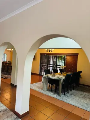 a dining room with a table and chairs at 150 Jacaranda Guesthouse in Midrand