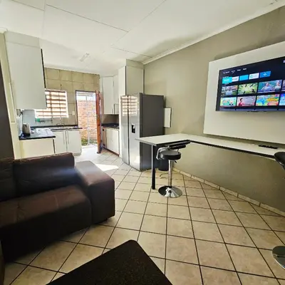 a living room with a couch and a table at ZUCH Accommodation at Pafuri Self Catering in Polokwane