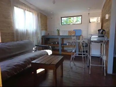 a living room with a couch and a table and chairs at Amaroks self catering units in Sabie