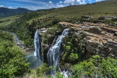 an aerial view of a waterfall in a field at Amaroks self catering units in Sabie