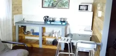 a kitchen with a table and chairs in a room at Amaroks self catering units in Sabie