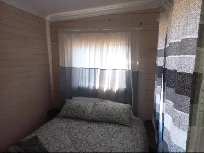 a small room with a bed and a window at Amaroks self catering units in Sabie
