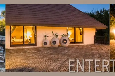 a house with two plants in vases in front of it at Amazing mountain views! Solar powered! in Hoedspruit