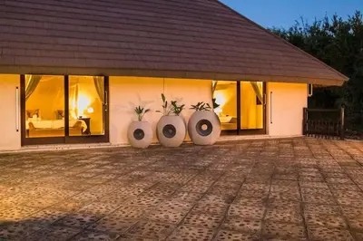 a house with three flower pots in front of it at Amazing mountain views! Solar powered! in Hoedspruit