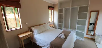 a small bedroom with a bed and a window at 3-Bedroom House, Greenway Woods, White River in White River