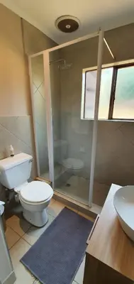 a bathroom with a toilet and a shower and a sink at 3-Bedroom House, Greenway Woods, White River in White River