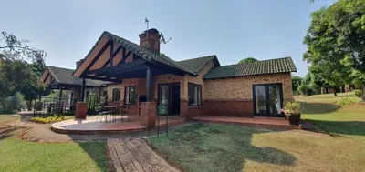 a brick house with a patio in the yard at 3-Bedroom House, Greenway Woods, White River in White River