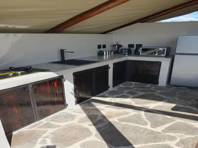 a kitchen with a sink and a counter top at Masorini Bush Lodge & Safari Tents in Phalaborwa