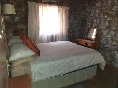 a bedroom with a bed and a window and a television at The Shoe Guest House in Draasloot