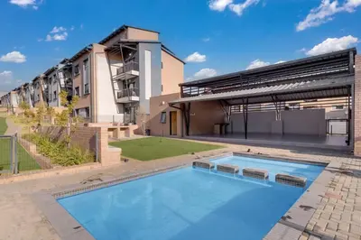 a large swimming pool in front of a building at Resting nest waterfall in Midrand