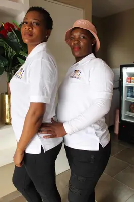 two women in uniform standing next to each other at Unit G Guest House in Ga-Mothiba