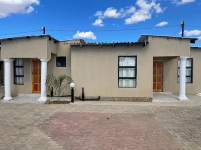 a house with two columns on a brick driveway at Unit G Guest House in Ga-Mothiba