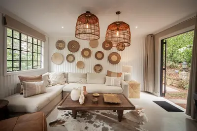 a living room with a white couch and a table at Viewpoint Estate Accommodation in Haenertsburg
