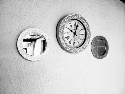 two mirrors and a clock on a wall at Be Our Guest Near OR TAMBO International Airport in Boksburg