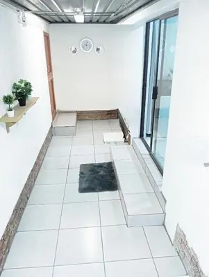 a room with white tile floors and a window at Be Our Guest Near OR TAMBO International Airport in Boksburg