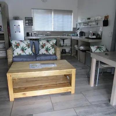 a living room with a couch and a table at Villa de Leeu, Perfect for Two in Marloth Park