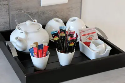 a shelf with three tea pots and some packets at Villa de Leeu, Perfect for Two in Marloth Park