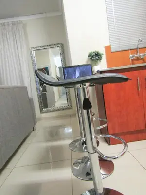 a laptop sitting on top of a stool in a kitchen at Khaya Guesthouse in Soshanguve