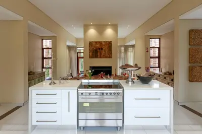 a kitchen with white cabinets and a stove at Lejwe La Metsi Self-Catering Villa in Bela-Bela