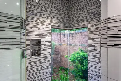 a bathroom with a shower with a glass door at Lejwe La Metsi Self-Catering Villa in Bela-Bela