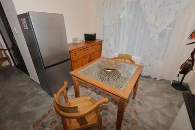 a kitchen with a table and a refrigerator at Oasis in the Wild @Marloth in Marloth Park