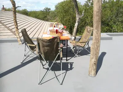 a table and two chairs on a patio at Oasis in the Wild @Marloth in Marloth Park