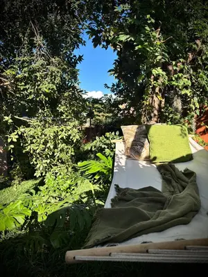 a bed with a green blanket on top of it at Fig Tree Rock 2-bed, 2-bath villa with garden and parking in Nelspruit