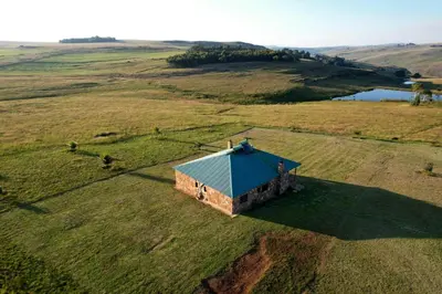 an aerial view of a small building in a field at Uitvlugt Ponds in Dullstroom