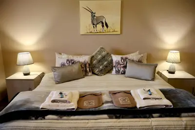 a bedroom with a bed with towels on it at Uitvlugt Ponds in Dullstroom