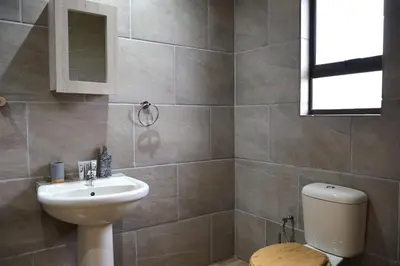 a bathroom with a sink and a toilet at Uitvlugt Ponds in Dullstroom