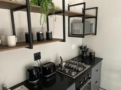a kitchen with a stove top oven in a kitchen at 46 on Allcock Guest Apartment & Luxury Room in Pretoria