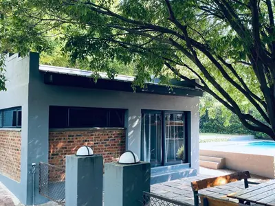 a building with two trash cans in front of it at 46 on Allcock Guest Apartment & Luxury Room in Pretoria