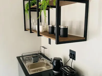 a bathroom with a sink and a mirror at 46 on Allcock Guest Apartment & Luxury Room in Pretoria