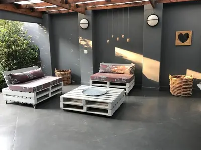a patio with two chairs and a table and chairs at 46 on Allcock Guest Apartment & Luxury Room in Pretoria