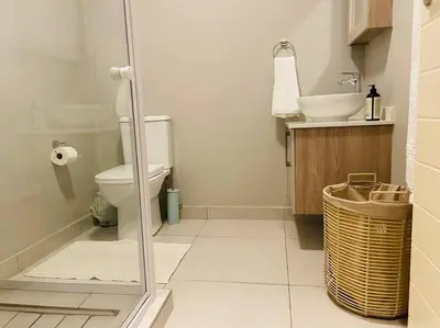 a bathroom with a toilet and a sink at Mikeys Place on Lever with Fibre Uncapped WiFi in Midrand