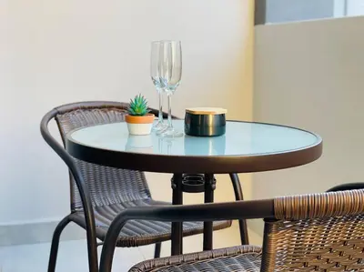 a table with two chairs and a wine glass at Mikeys Place on Lever with Fibre Uncapped WiFi in Midrand