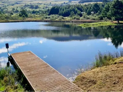 a dock on the side of a lake at Ukutula Resort in Dullstroom