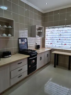 a kitchen with a stove and a counter top at Bela Valley Guest House in Bela-Bela