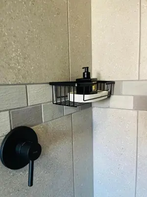 a black shelf on the side of a wall at Luxuries Penthouse in Nelspruit