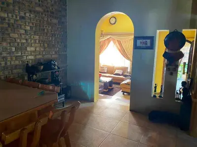 a living room with a table and a room with a window at Serenity Garden Place in Hazyview