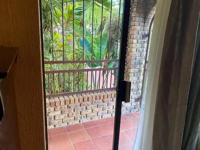 an open door with a view of a brick wall at Serenity Garden Place in Hazyview
