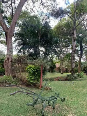 a green park bench sitting in the grass at Serenity Garden Place in Hazyview