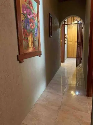 a hallway with a painting of flowers on the wall at Serenity Garden Place in Hazyview