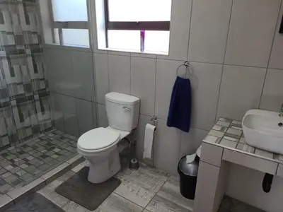 a bathroom with a toilet and a sink at Cats Corner in Marloth Park